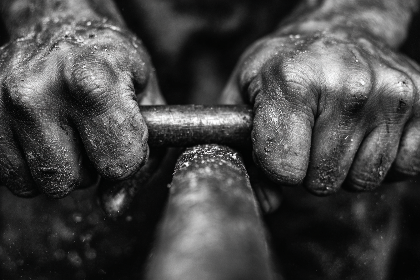 Craftsman hands on steel rod